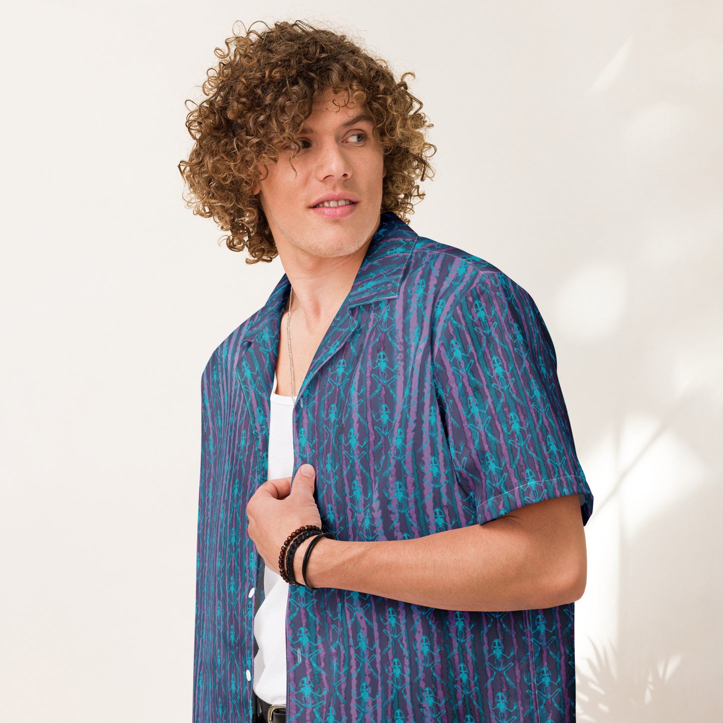 Close up of model wearing the Anura button down shirt with turquoise frog bones from the front.