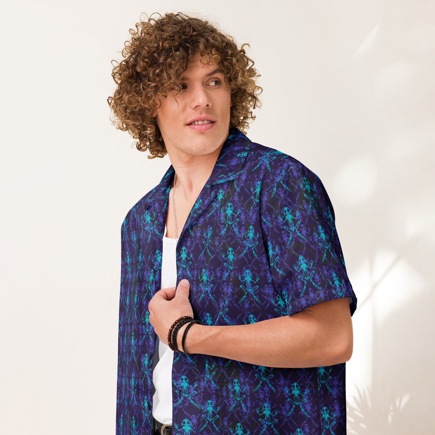 Close up of male model wearing the Anura Zeta Button down shirt with purple black and turquoise frog bones from the front quarter.