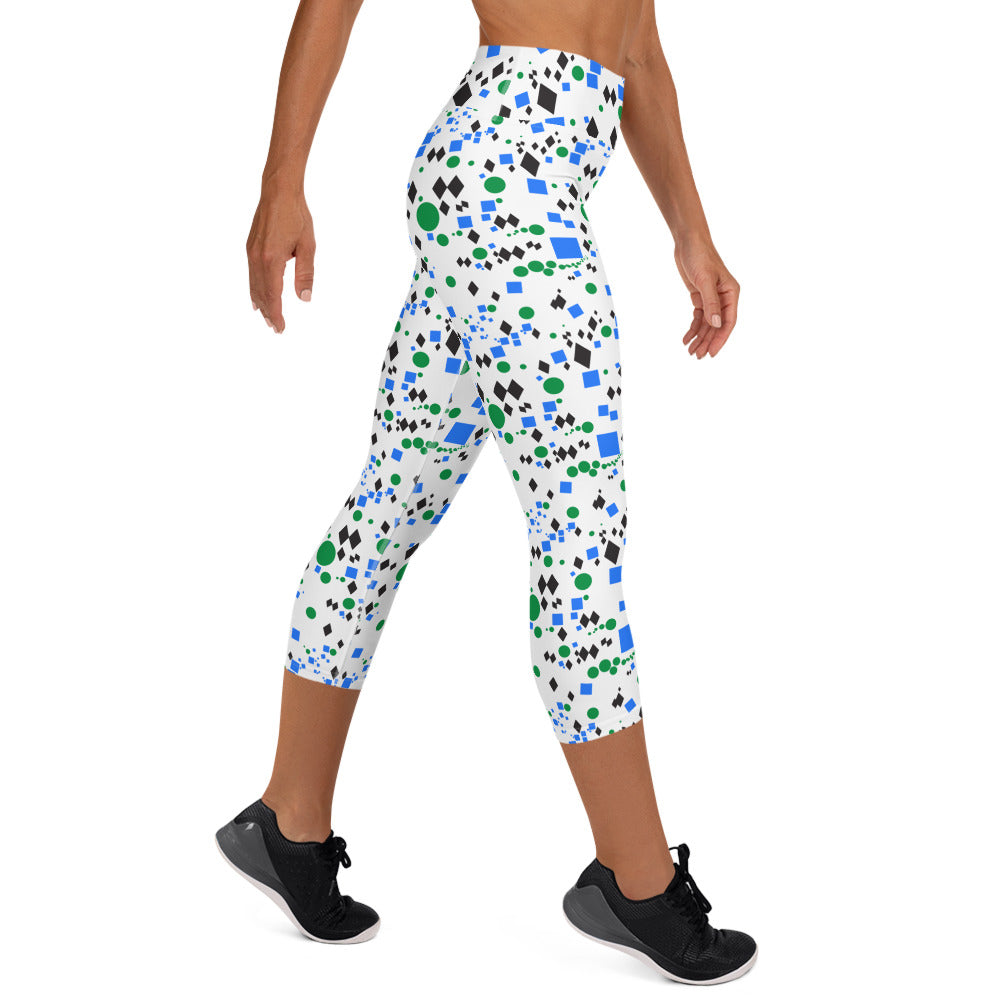 Woman modeling the Trail Marker capri leggings from the side on tiptoes.