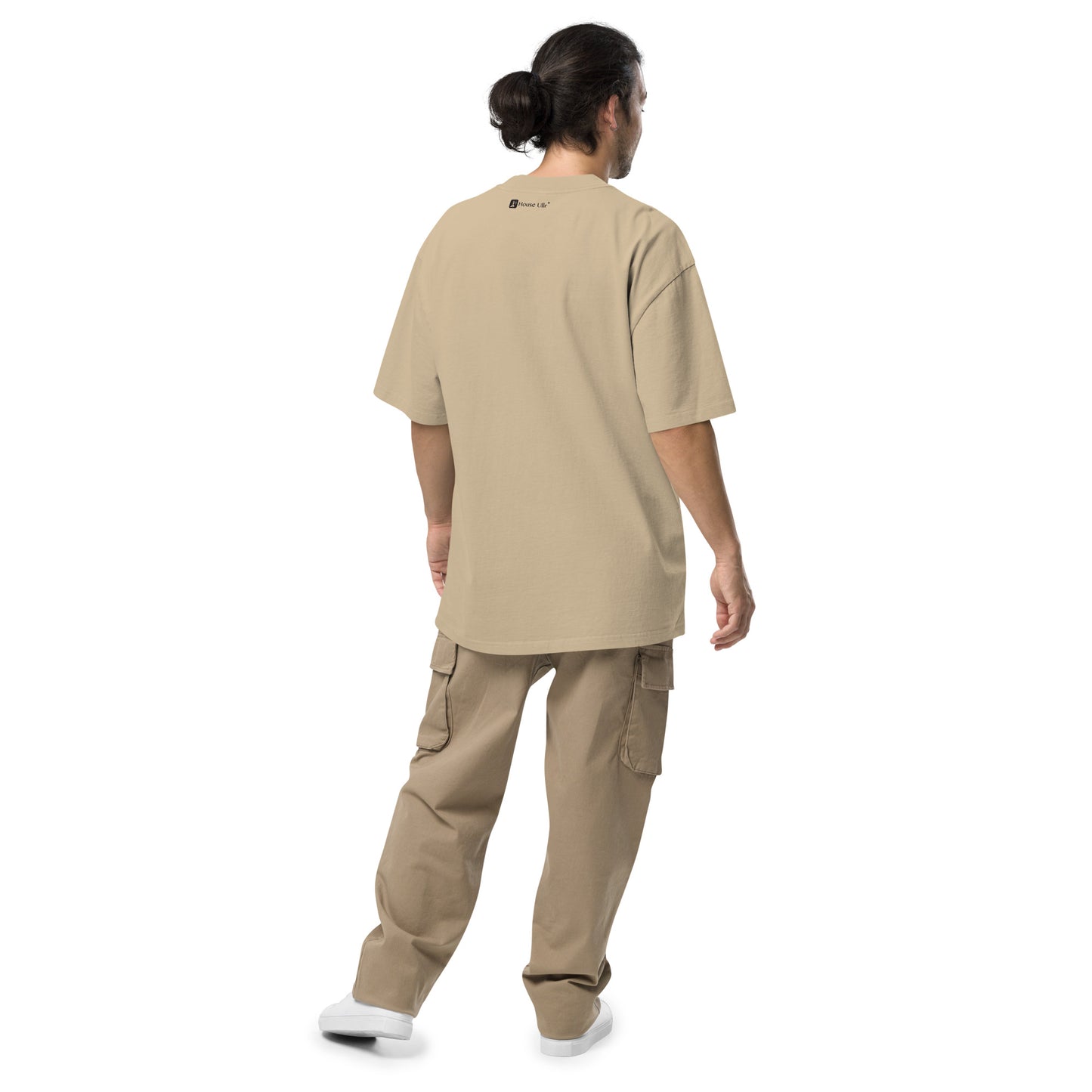 Dude Modeling the Birds of Peace Oversize T-shirt from the back in faded khaki color.