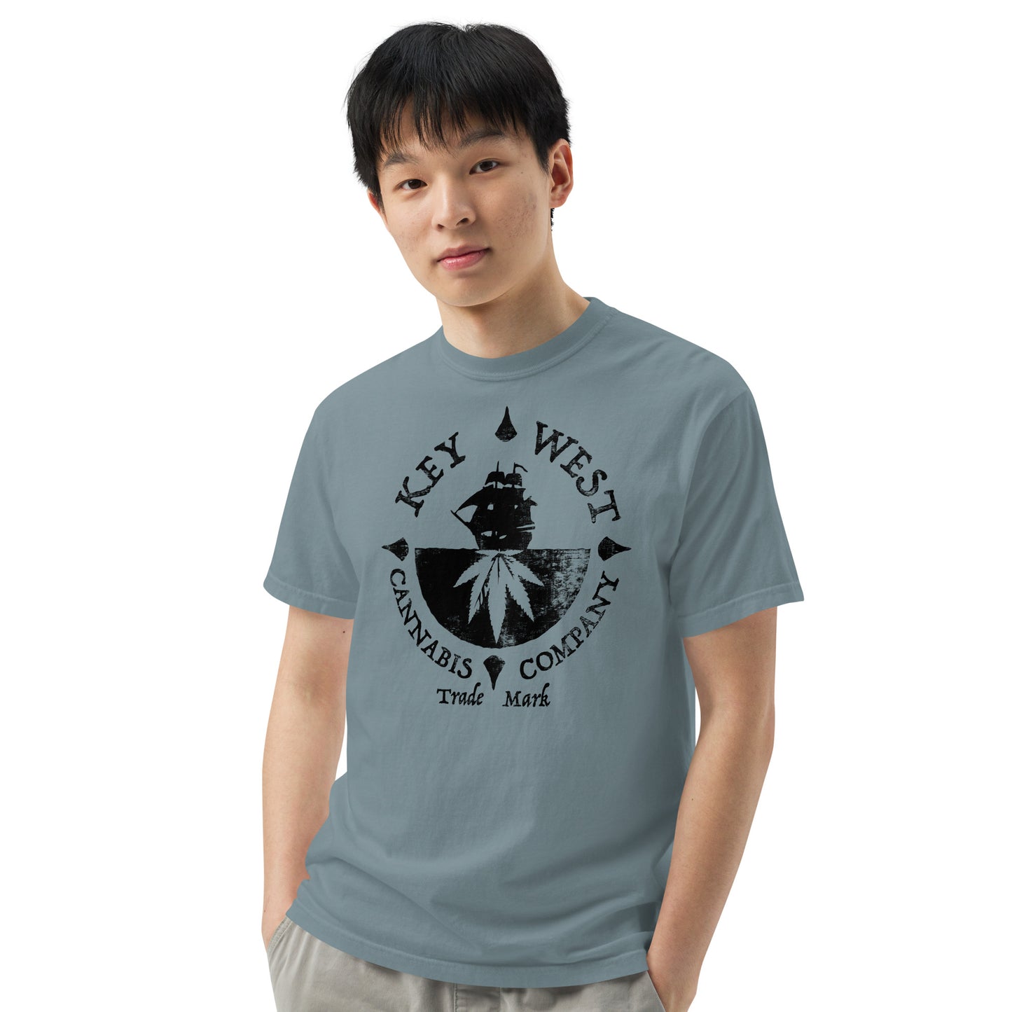 Man with hands in pockets modeling the Key West Cannabis Company Brand T-shirt in Ice Blue from the front.